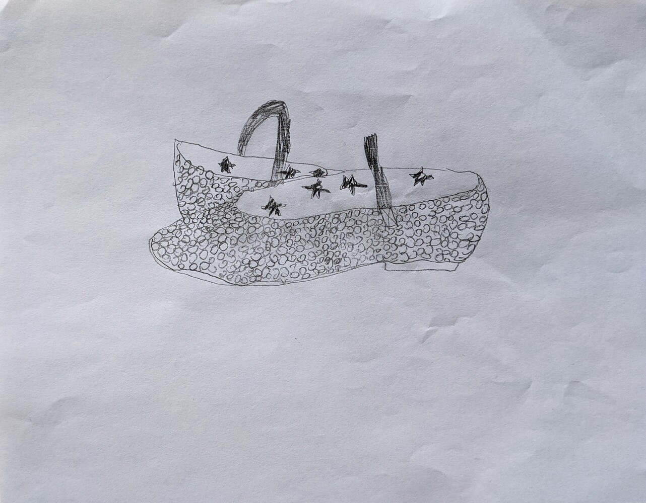 A pair of girls dress shoes drawn in pencil.