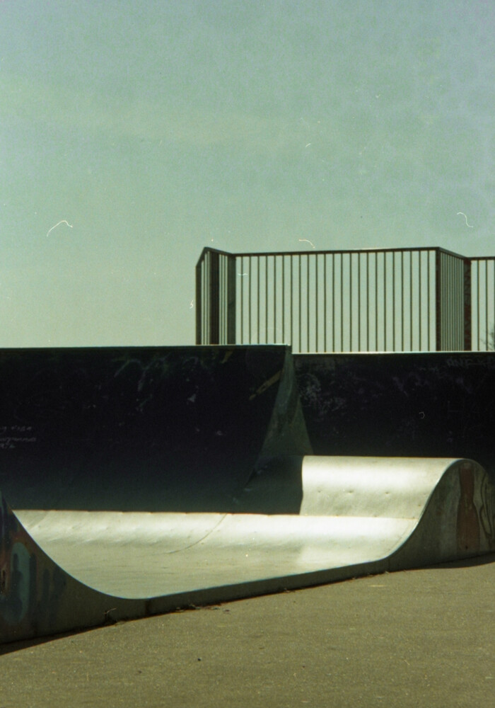 This image is of a skateboarding ramp, but photographed in a way that separates each curve, end and beginning of the ramp into a simple block colour, so the image looks more like a combination of shapes at first glance.