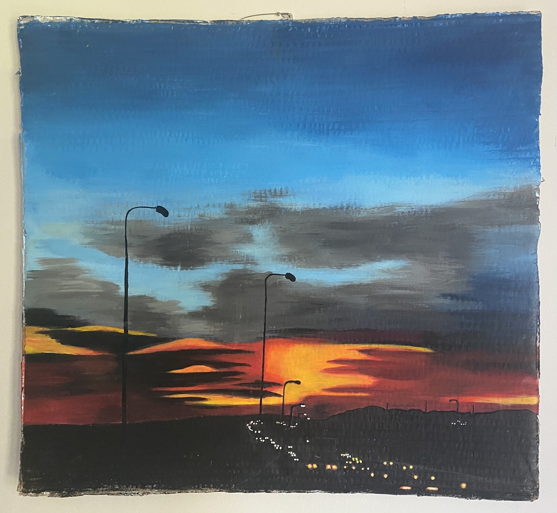This piece is a landscape piece on cardboard . The sky begins dark and then blends the into a lighter blue, before returning to an ominous grey, black and red horizon. The road is simple a silhouette. So are the lampposts that recede with the cars
